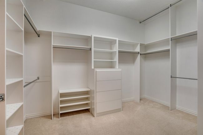 Spacious closet featuring light colored carpet | Image 22