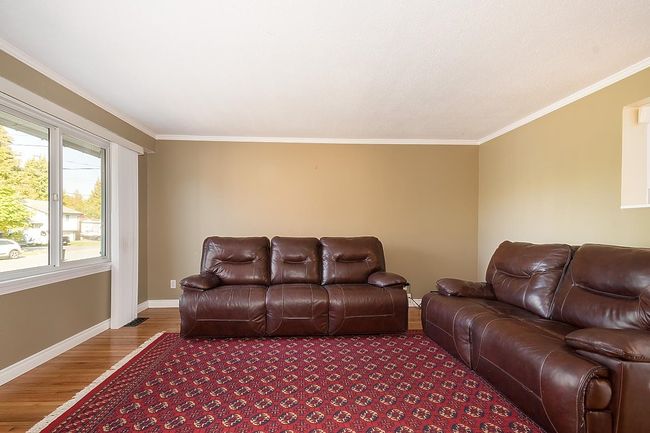 Living room with wood finished floors and ornamental molding | Image 5