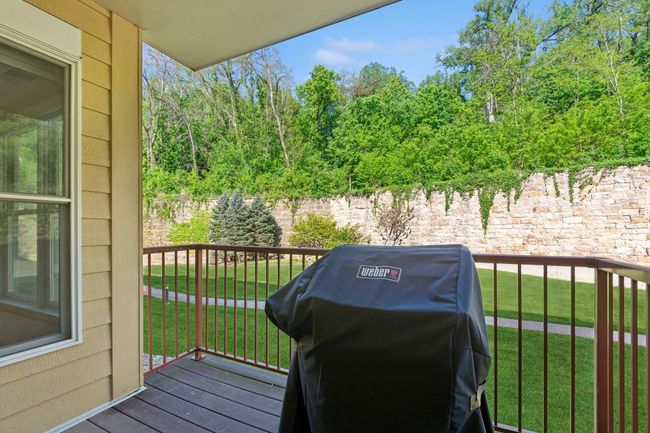 Private and peaceful, the deck overlooks the open green space behind the building. The Weber grill is plumbed directly into the natural gas line and remains with the unit. | Image 10