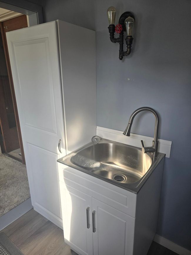 Laundry closet, utility sink, attractive light, new flooring | Image 10