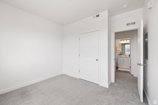 Unfurnished bedroom featuring light colored carpet and a closet | Image 15