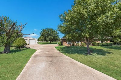 View of front of property with a garage, a front lawn, and an outbuilding | Image 3