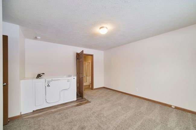 Primary bedroom leads to private bath | Image 25