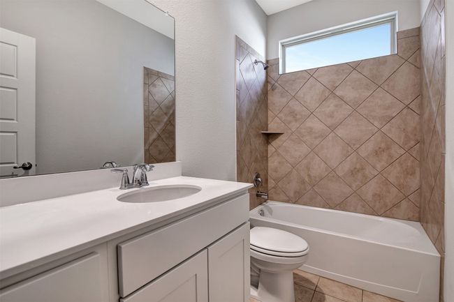 Bathroom with vanity, shower / tub combination, and tile patterned flooring | Image 25