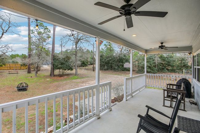 View of patio featuring ceiling fan and a porch | Image 31
