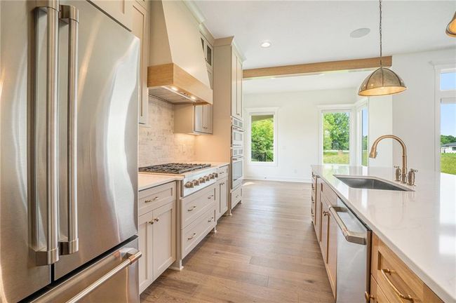 Kitchen with appliances with stainless steel finishes, a sink, custom exhaust hood, plenty of natural light, and recessed lighting | Image 26