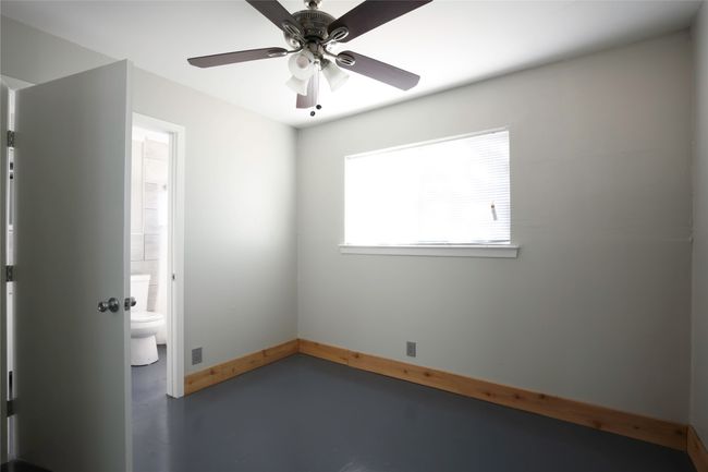 Empty room featuring finished concrete flooring and ceiling fan | Image 15