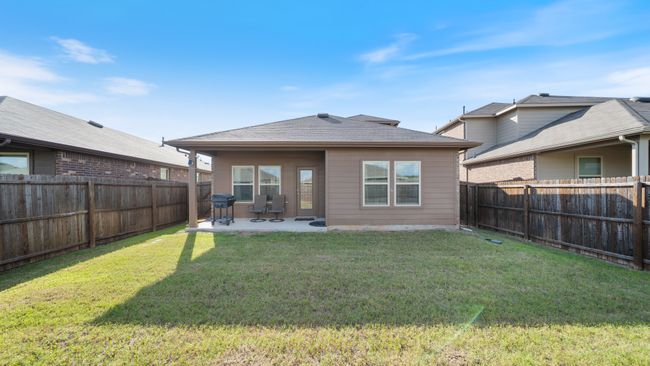 Rear view of house with a patio, a fenced backyard, and roof with shingles | Image 27