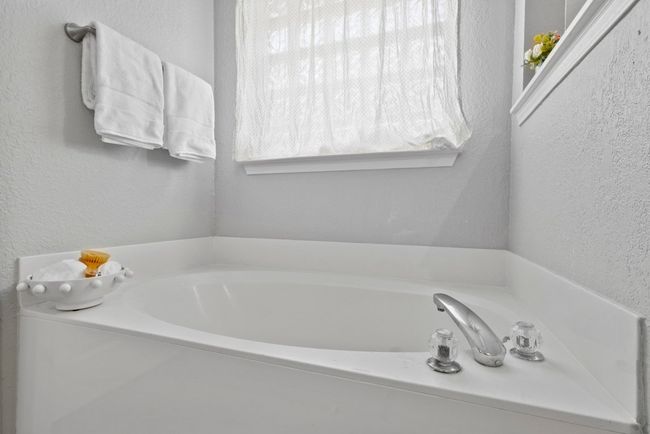Bathroom featuring a garden tub to relax in | Image 16