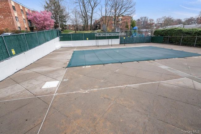 Community pool with a patio area and fence | Image 27