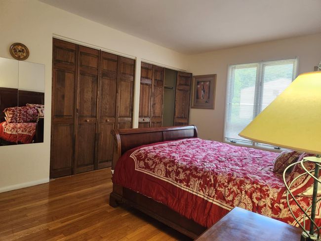 Bedroom with wood finished floors | Image 4