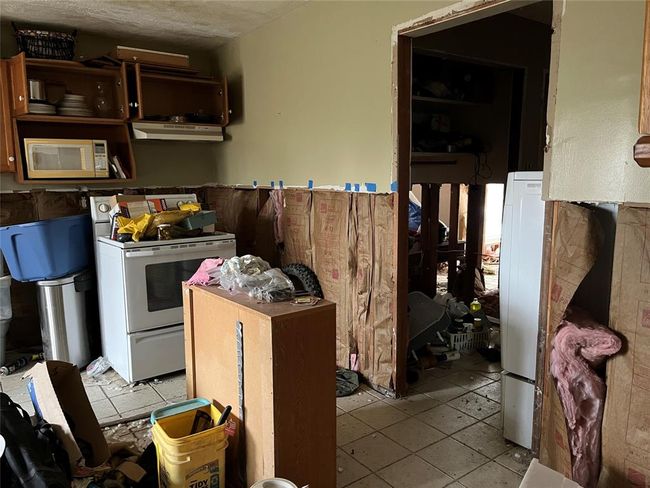 There's a laundry area to the right and it looks like a possible bath. | Image 24