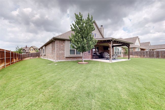 Rear view of property featuring brick siding, a patio area, and a chimney | Image 36