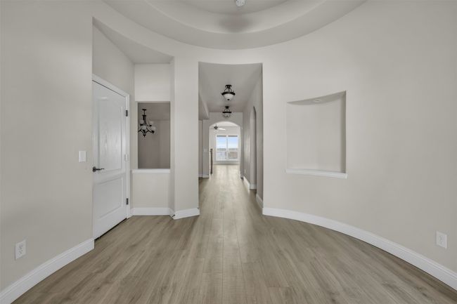 Corridor featuring a notable chandelier and light hardwood / wood-style floors | Image 11