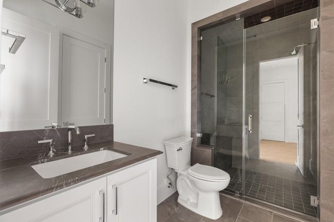 Shared between the bedroom and game room, this bathroom offers dual access points from both spaces. | Image 30