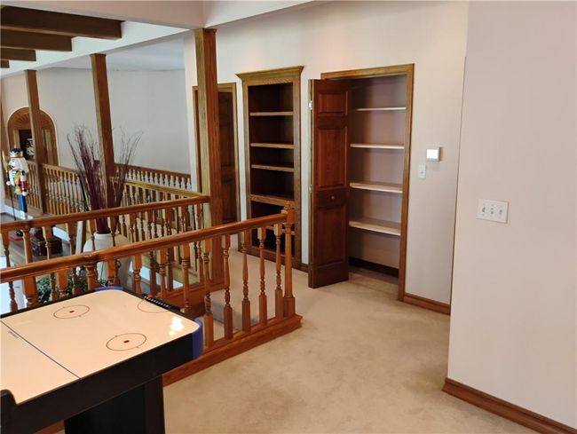 Upstairs Game room with light carpet and storage closets | Image 66