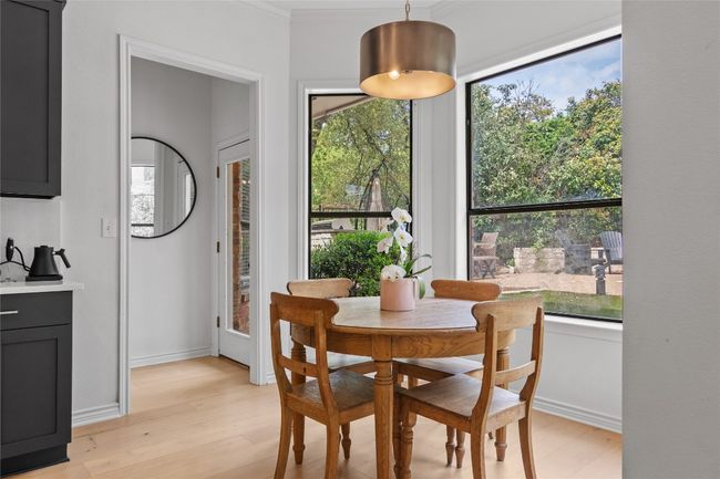 Dining area featuring baseboards, ornamental molding, and light wood-style flooring | Image 18