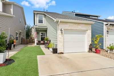 Sit on your front porch and sip some sweet tea while you look across the street and see a view of the water and marina docks. So peaceful! This home also backs to a greenbelt area with trees for privacy. | Image 2