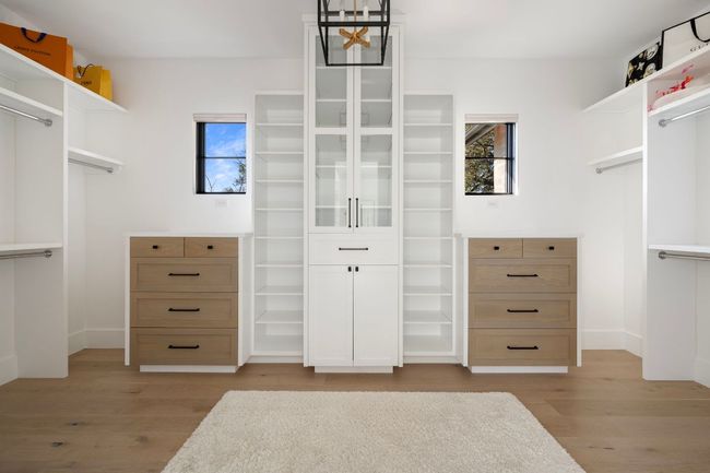 Spacious closet with light wood finished floors | Image 20