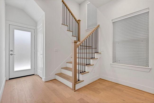 Hallway leading to stairs to 2nd floor and back yard. | Image 5