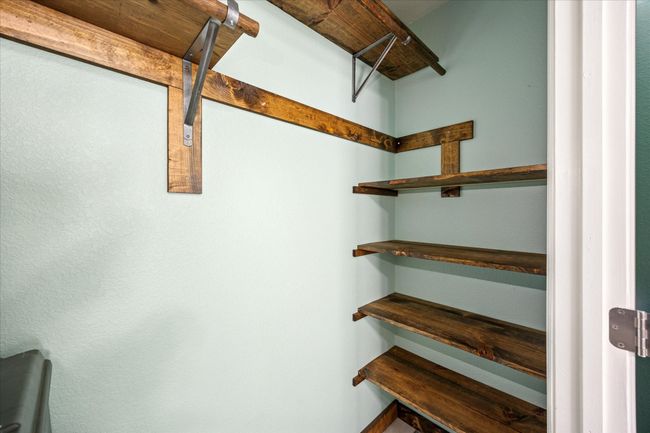 Secondary bedroom closet featuring custom shelving, offering organized storage and maximizing space. | Image 19