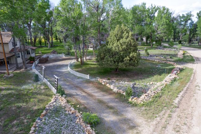 View of dirt / gravel road featuring view of wooded area | Image 43