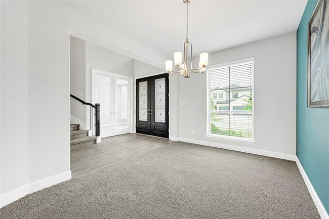 Modern, silver chandelier. Tall window in formal dining. | Image 5