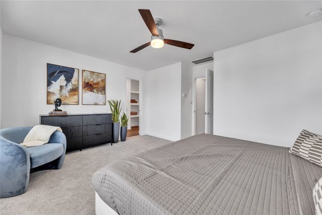 Bedroom with a ceiling fan, visible vents, and light carpet | Image 10