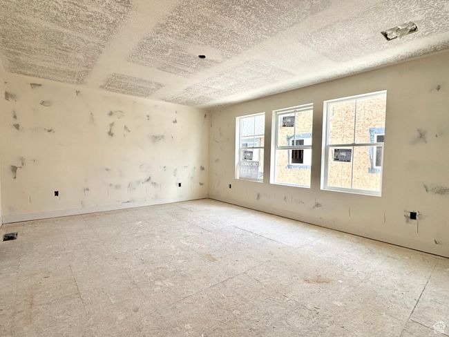 Empty room featuring a textured ceiling and baseboards | Image 16
