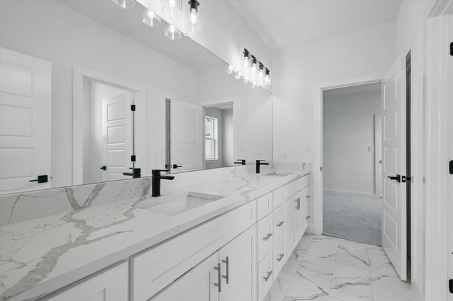 Bathroom featuring double vanity and marble finish floors | Image 32