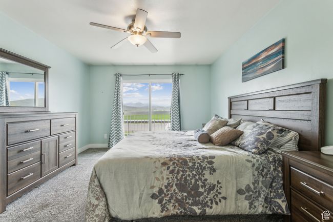 Bedroom with light colored carpet, access to exterior, ceiling fan, and baseboards | Image 8