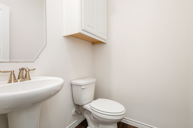 Bathroom featuring baseboards, a sink, and toilet | Image 15