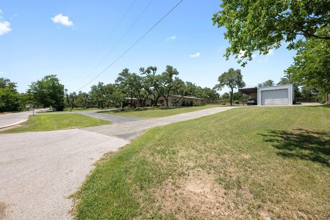 View of driveway leading to Large Industrial Metal Outbuilding . Connected paved driveway to main house. | Image 33