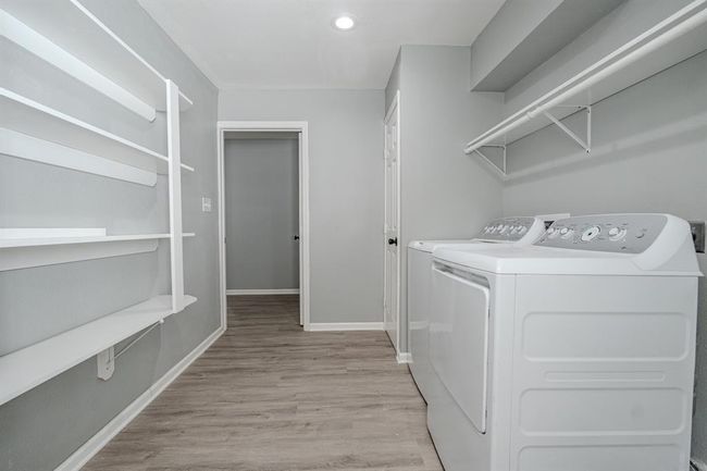 bright and functional laundry room that offer everything you need for efficient organization. Additional built-in shelves provide ample storage space. | Image 21