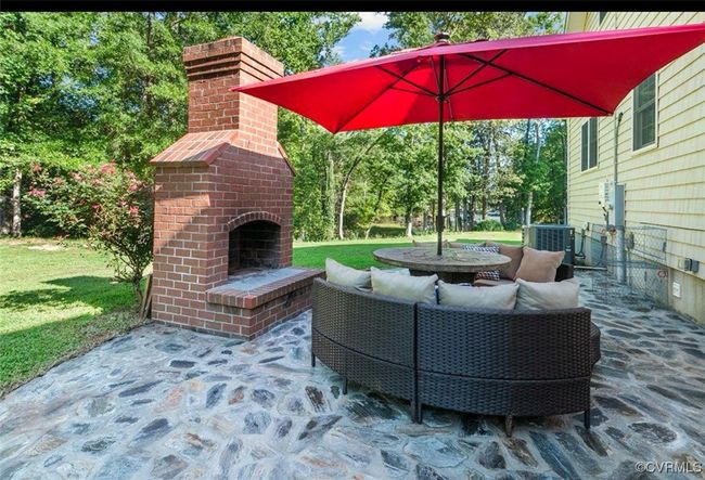 View of patio / terrace featuring an outdoor living space with a fireplace | Image 18