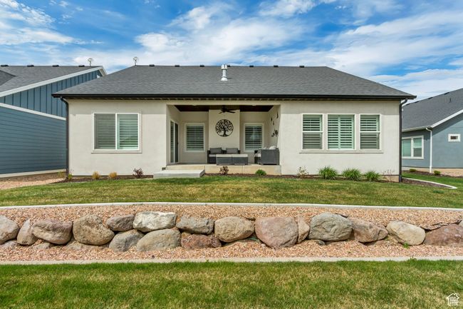 Rear view of house with a yard, outdoor lounge area, a ceiling fan, and a patio | Image 29
