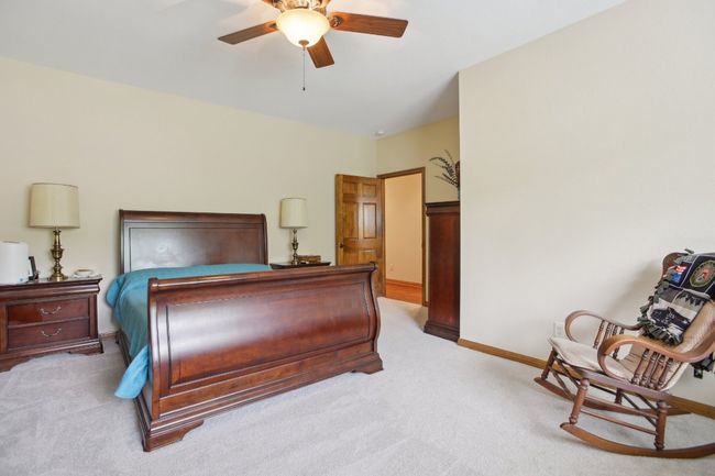 Carpeted bedroom with baseboards and ceiling fan | Image 11