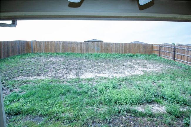 View of fenced backyard | Image 23
