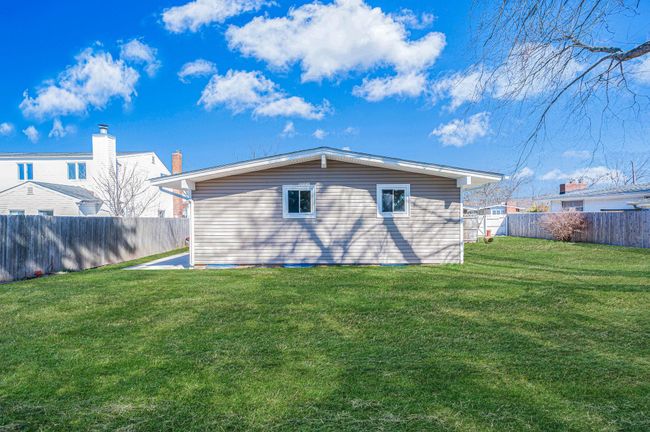 Back of property featuring a fenced backyard and a yard | Image 27