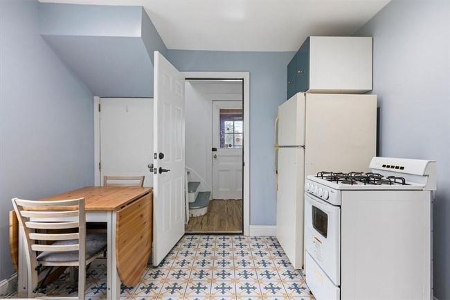 Kitchen featuring light tile patterned floors and white appliances | Image 5
