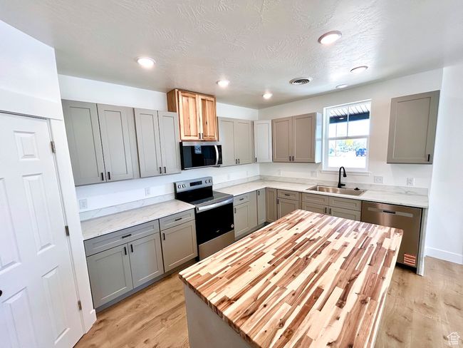 Kitchen with stainless steel appliances, gray cabinets, and a sink | Image 6