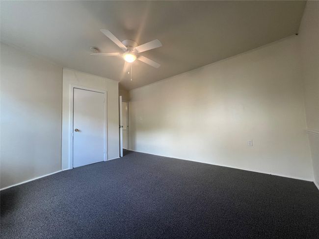 Carpeted spare room with a ceiling fan | Image 14