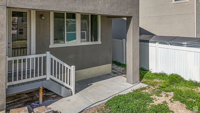 Doorway to property with a patio area, stucco siding, and fence | Image 43