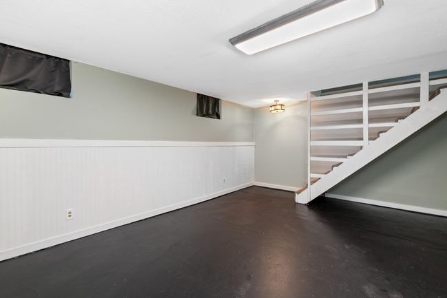 Finished basement with a wainscoted wall, baseboards, and stairs | Image 31