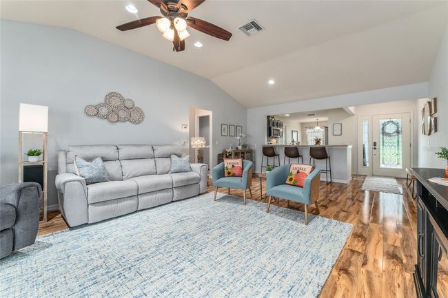 Living area to kitchen and front entry area. Furnishings, including power reclining sofa and chair are optional. | Image 9