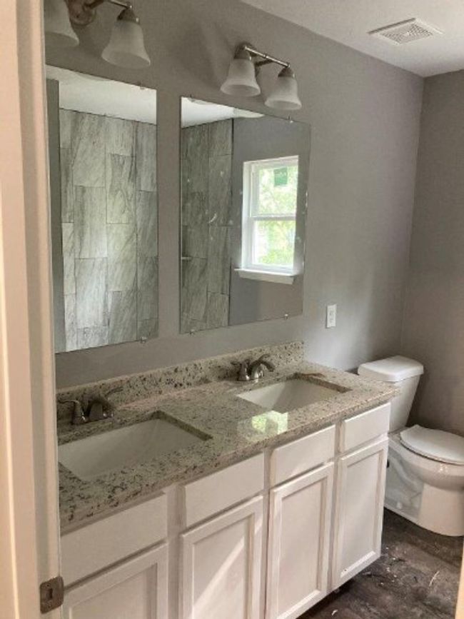 Full bath featuring toilet and double vanity | Image 8