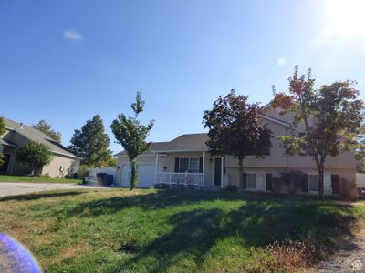 View of front facade featuring a porch and a front yard | Image 2