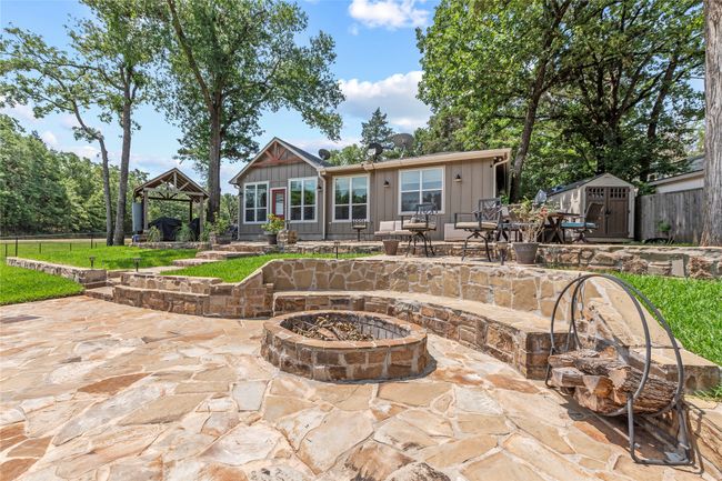 Back of main home with flagstone patio and fire pit | Image 19