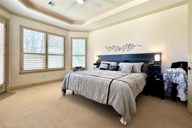 From there we can enter the primary bedroom, which has a good view of the back yard as well, with a door to be able to jump in the pool first thing in the morning! | Image 19