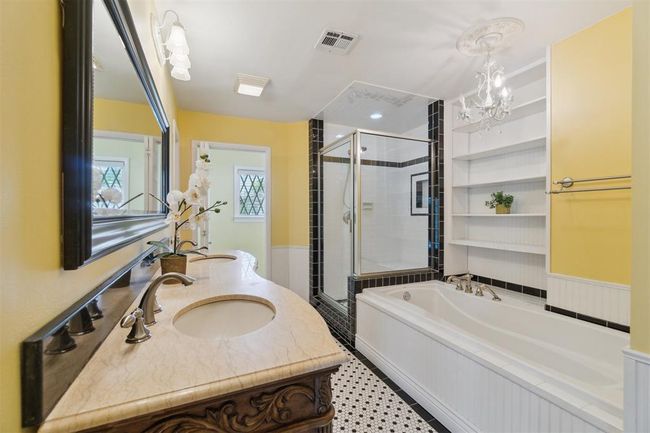 Full bathroom with a shower stall, a bath, double vanity, and a chandelier | Image 19